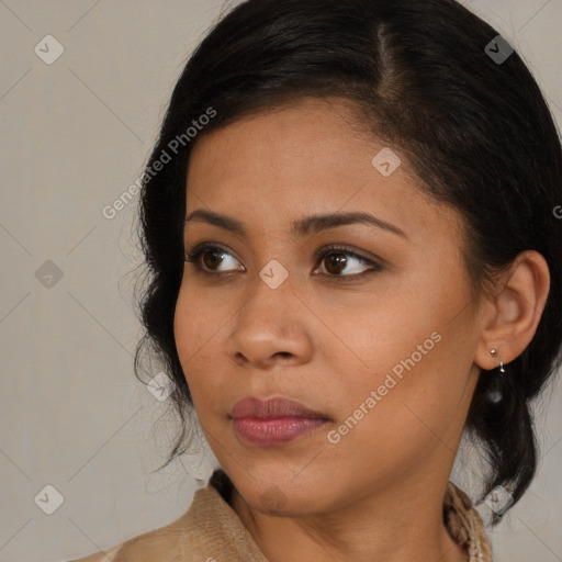 Joyful black young-adult female with medium  brown hair and brown eyes