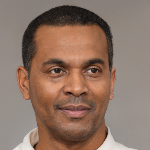 Joyful latino adult male with short  black hair and brown eyes