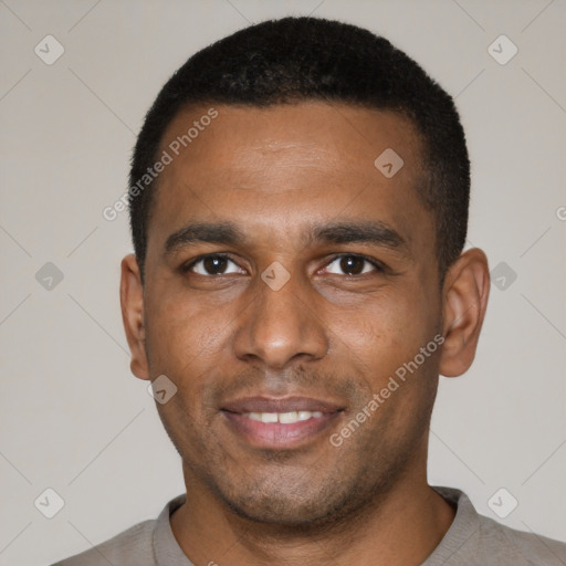 Joyful black young-adult male with short  black hair and brown eyes
