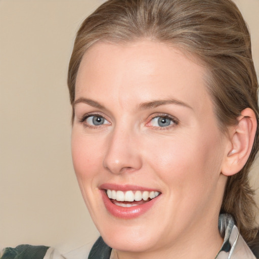 Joyful white adult female with medium  brown hair and grey eyes