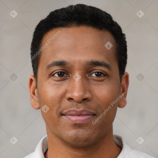 Joyful latino young-adult male with short  brown hair and brown eyes