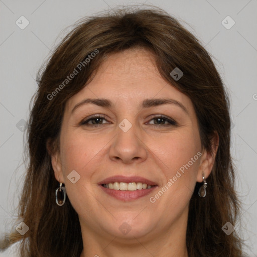 Joyful white adult female with long  brown hair and grey eyes