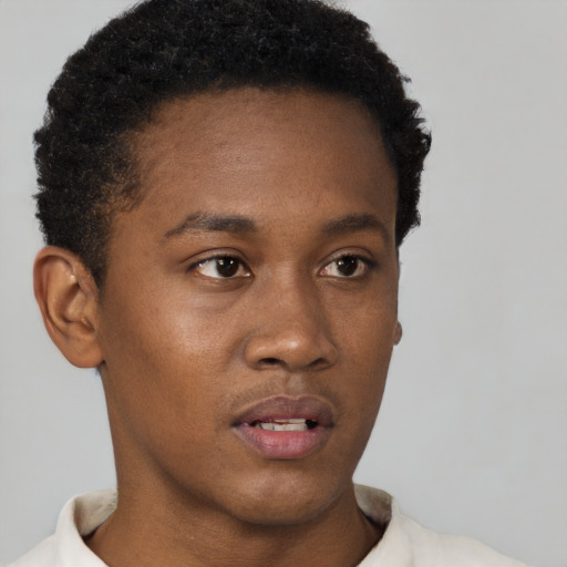 Neutral black young-adult male with short  black hair and brown eyes