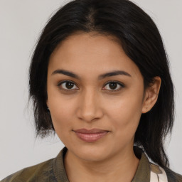 Joyful latino young-adult female with medium  brown hair and brown eyes