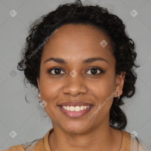 Joyful black young-adult female with long  black hair and brown eyes