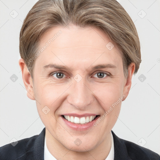 Joyful white adult female with short  brown hair and grey eyes