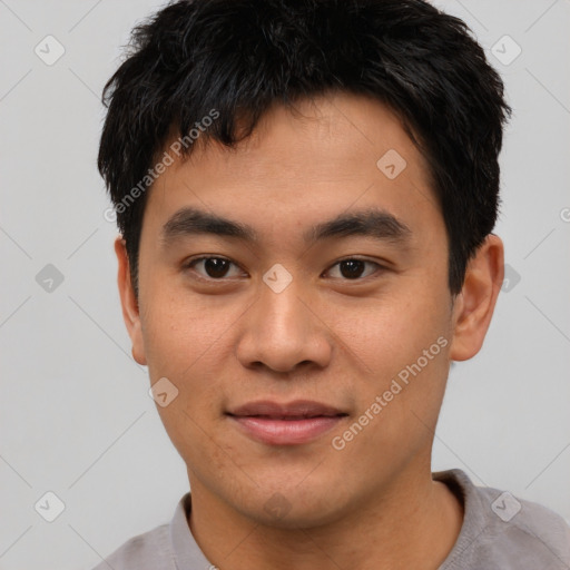 Joyful asian young-adult male with short  black hair and brown eyes