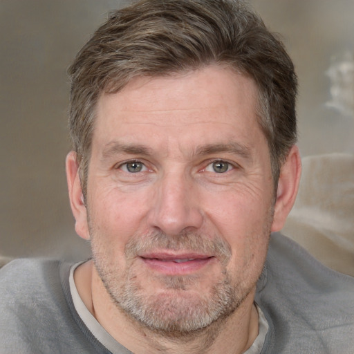 Joyful white adult male with short  brown hair and grey eyes