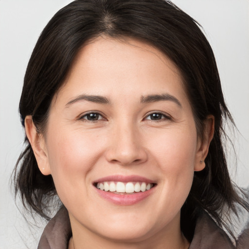 Joyful white young-adult female with medium  brown hair and brown eyes