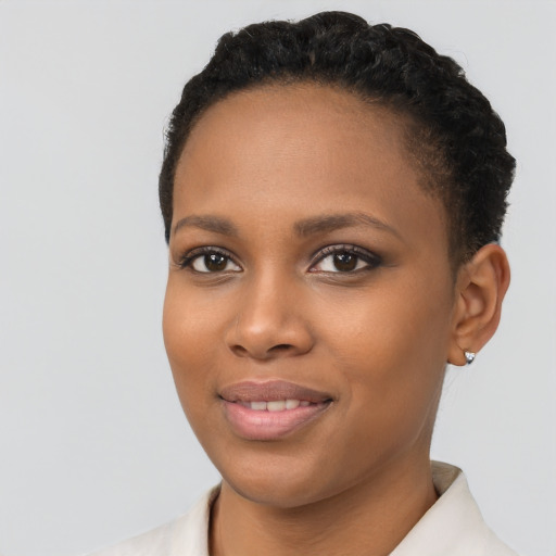 Joyful black young-adult female with short  black hair and brown eyes