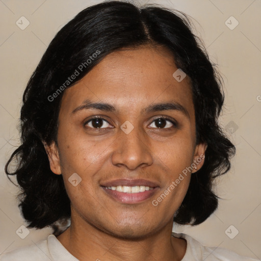 Joyful black adult female with medium  brown hair and brown eyes