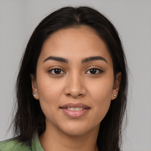 Joyful latino young-adult female with long  brown hair and brown eyes