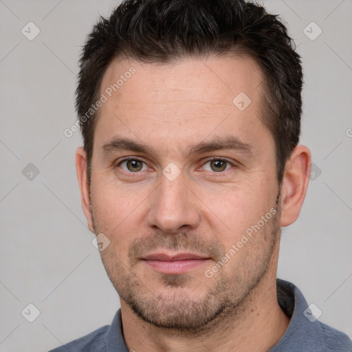 Joyful white adult male with short  brown hair and brown eyes