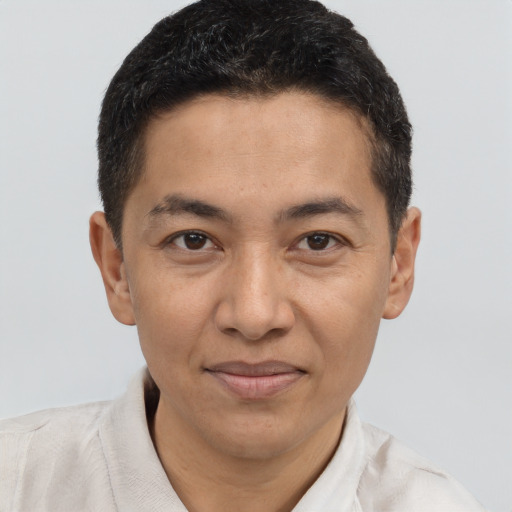 Joyful latino adult male with short  brown hair and brown eyes