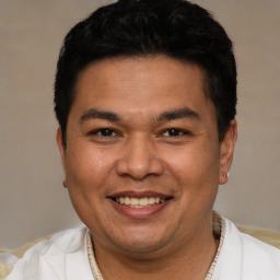 Joyful white adult male with short  black hair and brown eyes