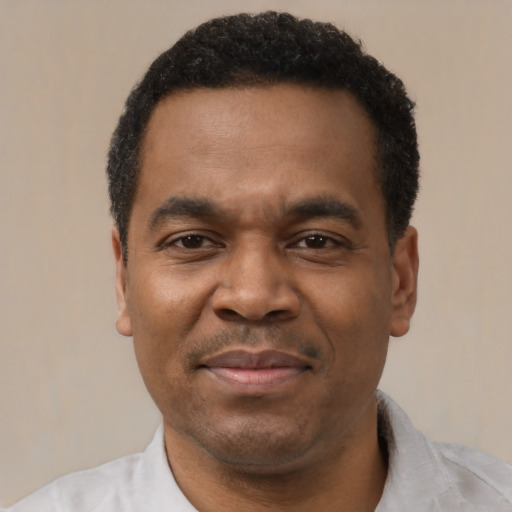 Joyful latino adult male with short  black hair and brown eyes