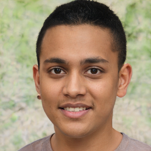 Joyful latino young-adult male with short  brown hair and brown eyes