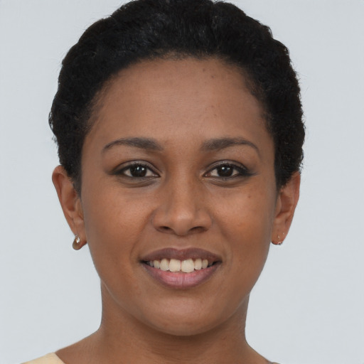 Joyful black young-adult female with short  brown hair and brown eyes