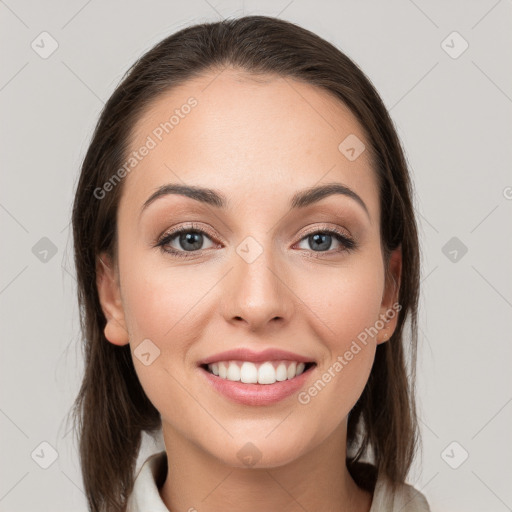 Joyful white young-adult female with medium  brown hair and grey eyes