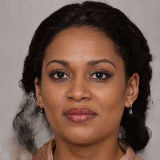 Joyful black young-adult female with medium  brown hair and brown eyes