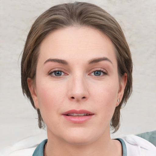 Joyful white young-adult female with medium  brown hair and blue eyes