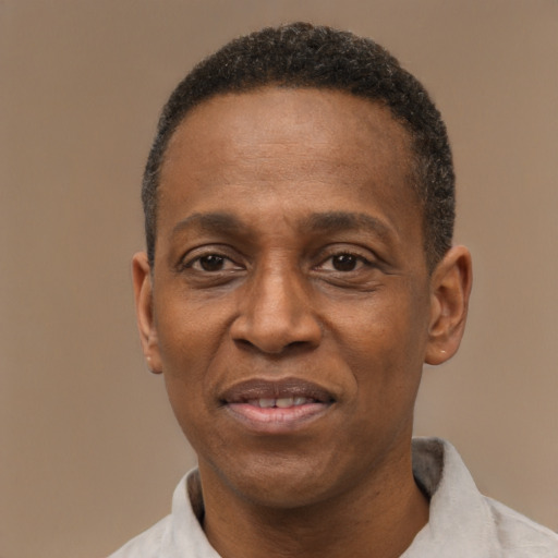Joyful black adult male with short  black hair and brown eyes