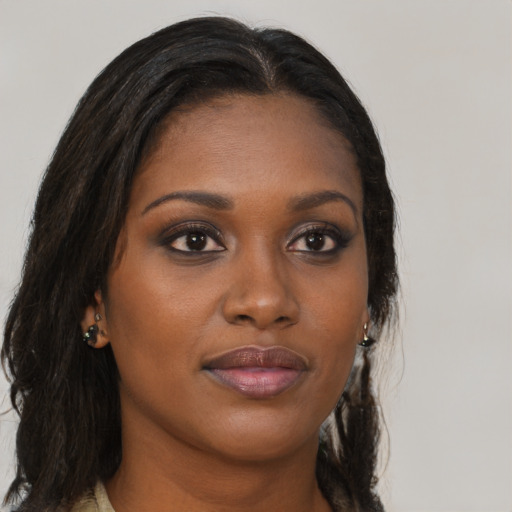 Joyful black young-adult female with long  brown hair and brown eyes