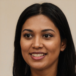 Joyful latino young-adult female with long  black hair and brown eyes