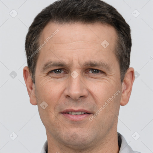 Joyful white adult male with short  brown hair and brown eyes