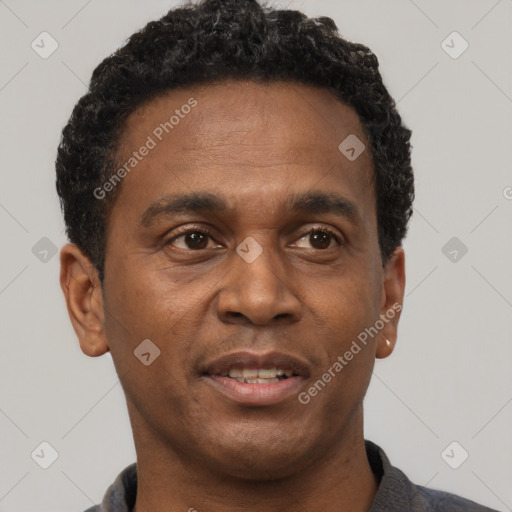 Joyful black young-adult male with short  brown hair and brown eyes