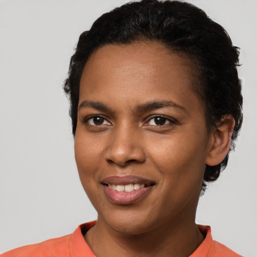 Joyful latino young-adult female with short  black hair and brown eyes