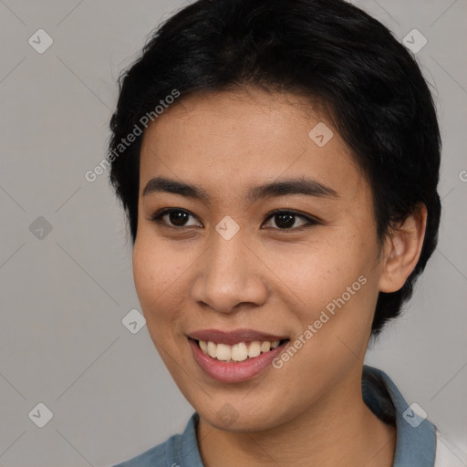 Joyful asian young-adult female with short  black hair and brown eyes