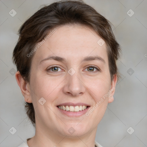 Joyful white adult female with medium  brown hair and grey eyes