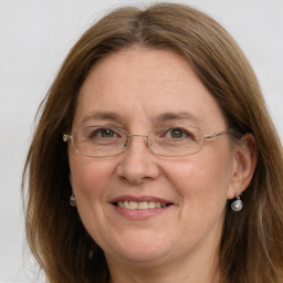 Joyful white adult female with long  brown hair and grey eyes