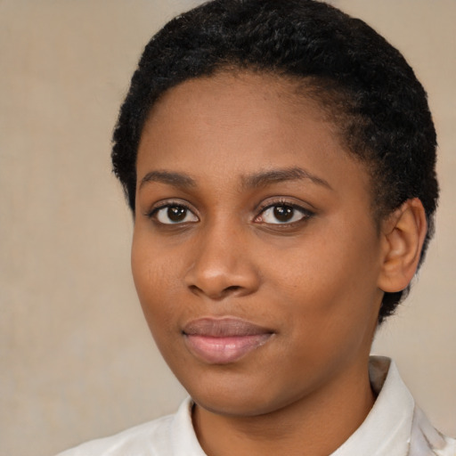 Joyful black young-adult female with short  brown hair and brown eyes