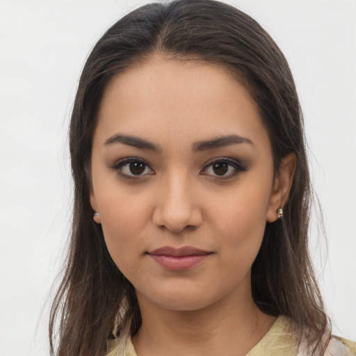 Joyful latino young-adult female with long  brown hair and brown eyes