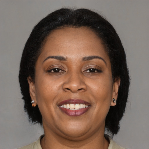 Joyful latino adult female with medium  brown hair and brown eyes