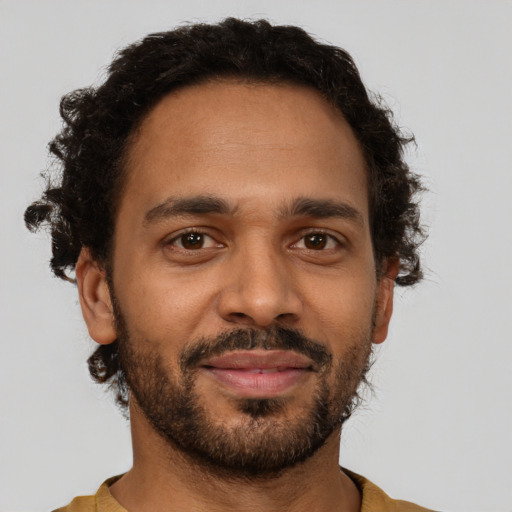 Joyful black young-adult male with short  brown hair and brown eyes