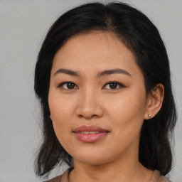 Joyful asian young-adult female with medium  black hair and brown eyes