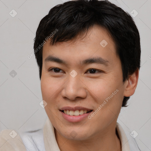 Joyful asian young-adult male with short  brown hair and brown eyes