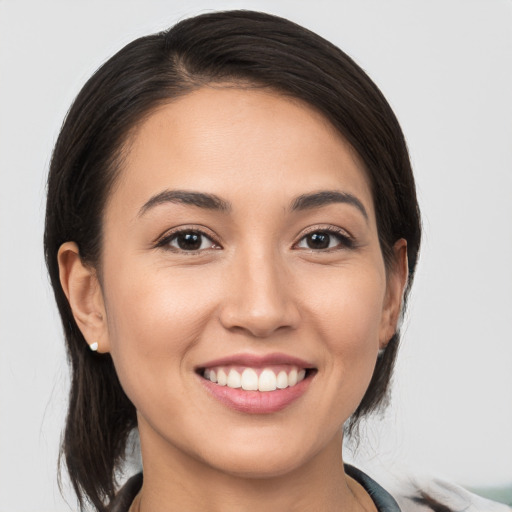 Joyful white young-adult female with medium  brown hair and brown eyes