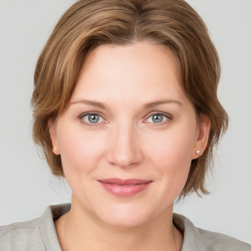 Joyful white young-adult female with medium  brown hair and blue eyes