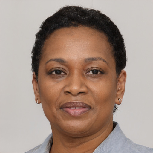 Joyful black adult female with short  black hair and brown eyes