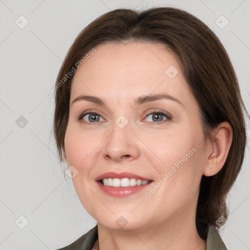 Joyful white young-adult female with medium  brown hair and grey eyes