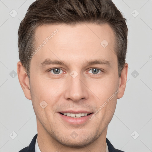 Joyful white young-adult male with short  brown hair and grey eyes