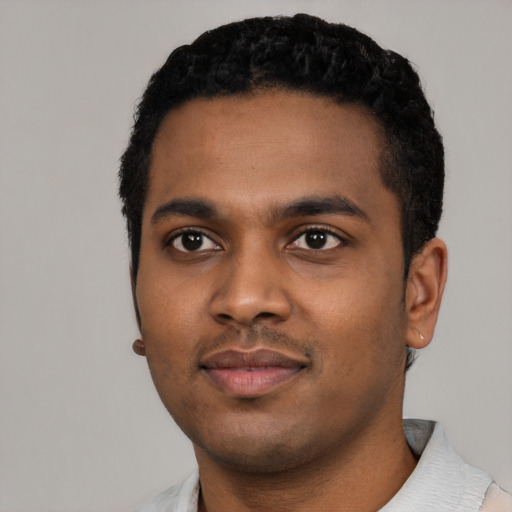 Joyful black young-adult male with short  black hair and brown eyes