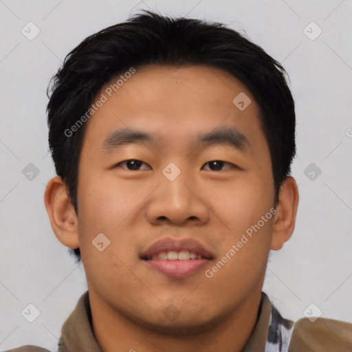 Joyful asian young-adult male with short  black hair and brown eyes