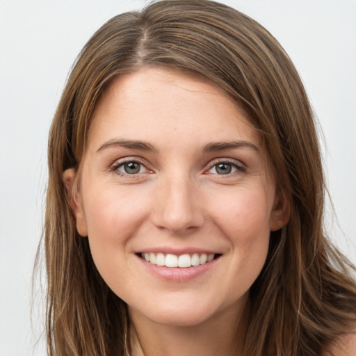 Joyful white young-adult female with long  brown hair and grey eyes