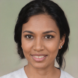 Joyful latino young-adult female with medium  black hair and brown eyes