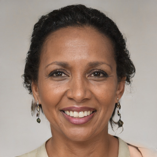 Joyful black adult female with medium  brown hair and brown eyes